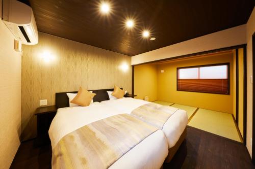 a bedroom with a large bed in a room at Rinn Hanayacho Asagiri in Kyoto