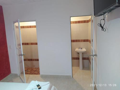 a bathroom with a shower and a sink at Hotel Bello Caribe Express in Cozumel