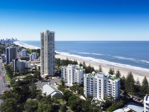 a large city with a lot of palm trees at Burleigh Mediterranean Resort in Gold Coast