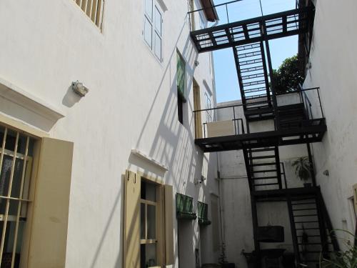 a white building with a fire escape on the side at Ren I Tang Heritage Inn in George Town