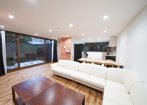 a living room with a white couch and a table at Villa Liberte Hakone Gora in Hakone