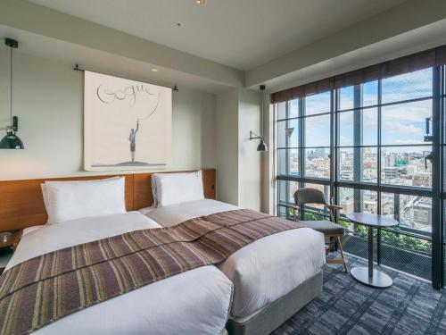 Ένα ή περισσότερα κρεβάτια σε δωμάτιο στο Ebisuholic Hotel