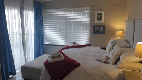 a bedroom with a large bed with towels on it at The Haven in Jongensfontein