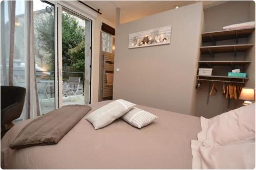 a bedroom with a bed with two pillows on it at Villa Eugénie Melun in Melun