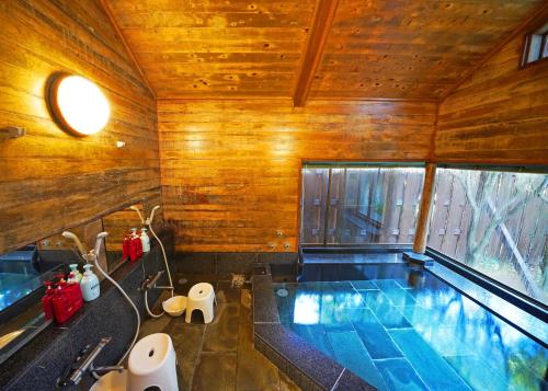 a bathroom with a swimming pool in a house at Villa Liberte Hakone Gora in Hakone
