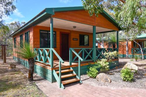 a small house with a staircase leading to it at Gracetown Caravan Park in Gracetown