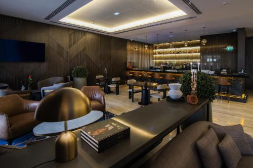 a lobby with a bar with a table and chairs at K Hotel Douala in Douala