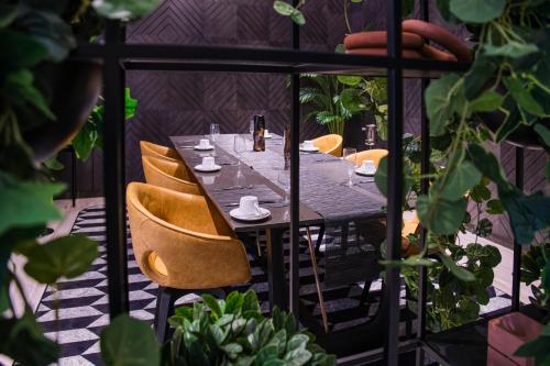 a table on a balcony with chairs around it at K Hotel Douala in Douala