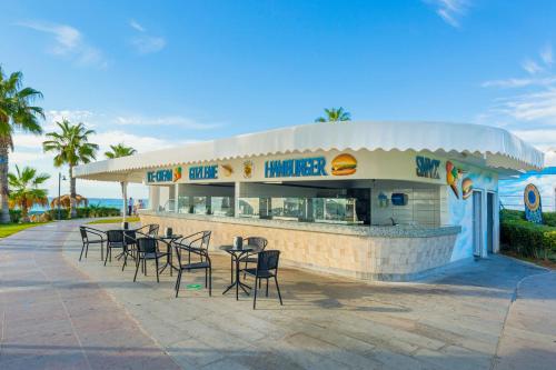 a restaurant with chairs and tables in front of it at Justiniano Club Park Conti in Okurcalar