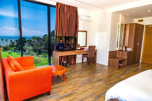 a bedroom with a desk and a bed with a view at KEP BAY HOTEL & RESORT in Kep