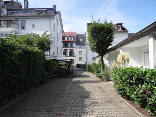 a cobblestone street in a city with white buildings at Apartment-EG-04 in Darmstadt