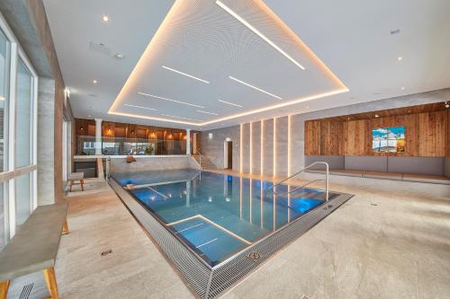 a swimming pool in the middle of a building at Hotel Römerhof in Fusch an der Glocknerstraße