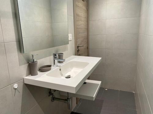 a bathroom with a white sink and a mirror at PROBER_LES BONS in Encamp