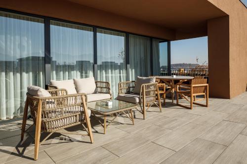 a patio with chairs and a table on a balcony at Qosmo Brasov Hotel in Braşov