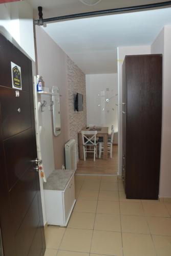 a room with a door and a kitchen with a table at Apartman Ema BIG 64m2-duplex Kopaonik in Kopaonik