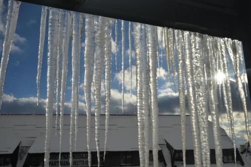 a group of icicles hanging from a building at Apartman Ema BIG 64m2-duplex Kopaonik in Kopaonik
