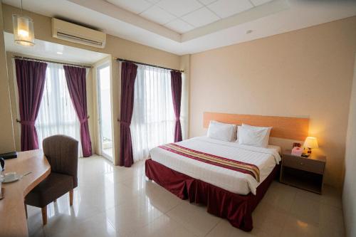 Ένα ή περισσότερα κρεβάτια σε δωμάτιο στο Bangka City Hotel