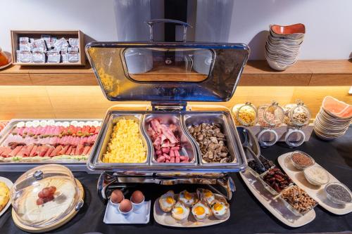 a buffet with many trays of food on a table at Forum Boutique Hotel & Spa - Adults Only in Alcudia