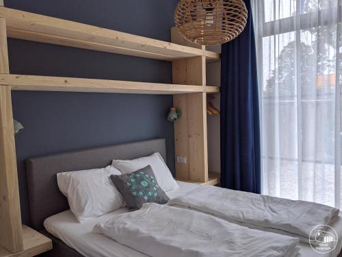 a bedroom with a bunk bed with white sheets and pillows at Nieuw Molenwijk 4-5 persoons in Oostkapelle