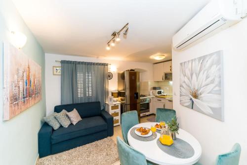 a living room with a table and a couch at Holiday Home Kazerma in Dubrovnik
