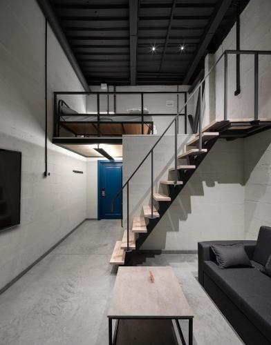 a living room with a couch and a staircase at Campus Community A-Hotel in Kyiv