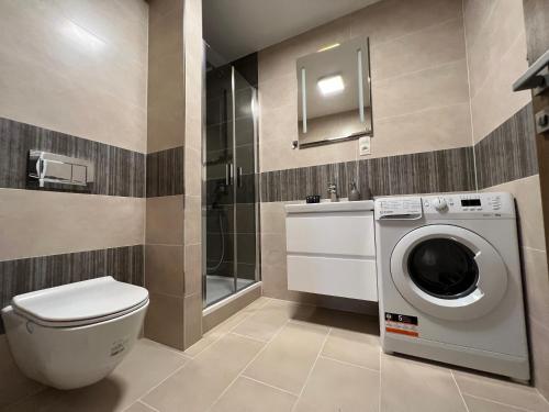 a bathroom with a toilet and a washing machine at Apartman Centrum 401 in Ústí nad Labem