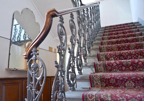 a stairway with red and silver carpeted stairs at Hotel Arno Bellariva in Florence