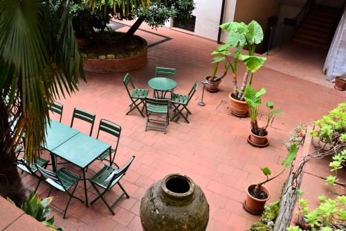a patio with a table and chairs and plants at Hotel Arno Bellariva in Florence