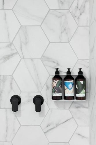 a bathroom with two bottles of soap on a wall at ISLA Tel Aviv in Tel Aviv