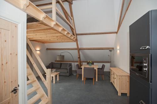 a room with a loft with a table and a couch at Bed & Breakfast Notterveld in Notter