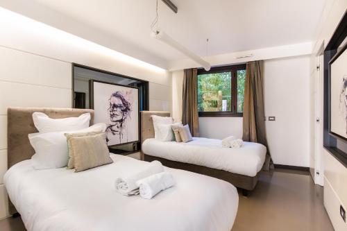 Ένα ή περισσότερα κρεβάτια σε δωμάτιο στο Villa Alexandra - Luxury Apartments Jardins d'ARLIAS by Sweett