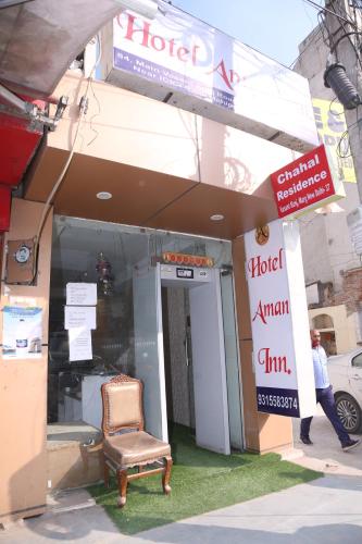 a store front with a chair outside of it at Hotel Aman Inn With early check in in New Delhi
