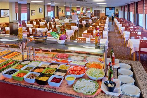 a buffet line with many different types of food at GHT Balmes, Hotel-Aparthotel&SPLASH in Calella