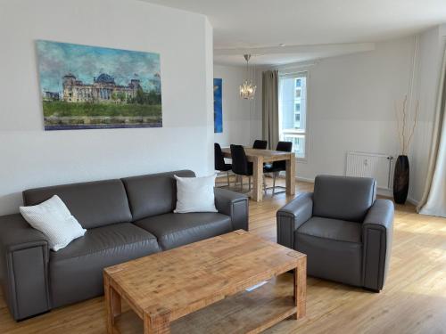 a living room filled with furniture and a couch at Apartments am Brandenburger Tor in Berlin