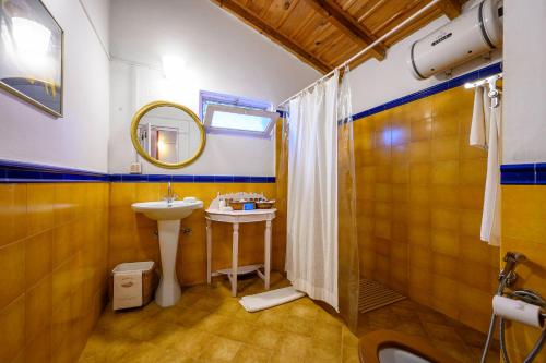 a bathroom with a sink and a mirror at Neemrana's - Ramgarh Bungalows in Rāmgarh