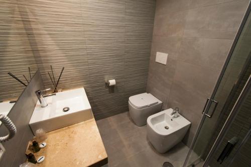 a bathroom with a sink and a toilet and a shower at Villa Aurelia in Rome