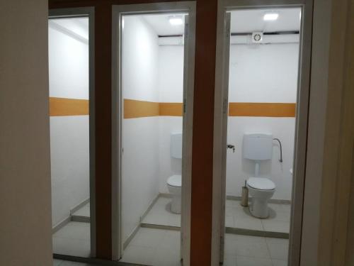 a bathroom with two toilets in a room at Surf House Hostel in Santa Maria