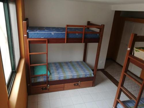 a room with two bunk beds in a room at Surf House Hostel in Santa Maria