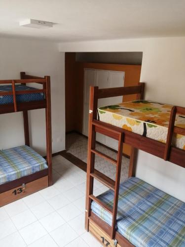 a room with two bunk beds and a bed at Surf House Hostel in Santa Maria