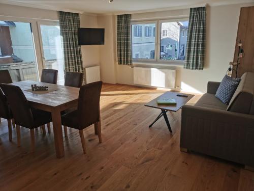 a living room with a table and a couch at Premium Appartements Di Bora in Sankt Michael im Lungau