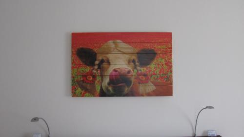 a painting of a cow on a wall at Gästehaus Zum Steirischen Kuss in Aich