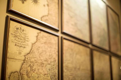 a map hanging on a wall next to a window at voco Grand Central Glasgow by IHG in Glasgow
