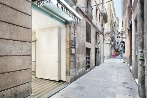 فندق California في برشلونة: زقاق فارغ مع باب أبيض على مبنى