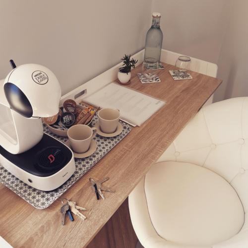 a table with a coffee maker and cups on it at Casa Lennisa in La Vall de Laguar
