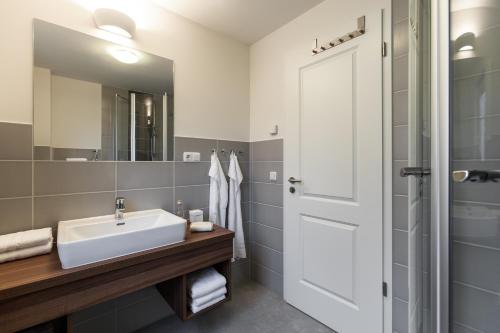 a bathroom with a sink and a mirror at StrandResort Markgrafenheide in Warnemünde