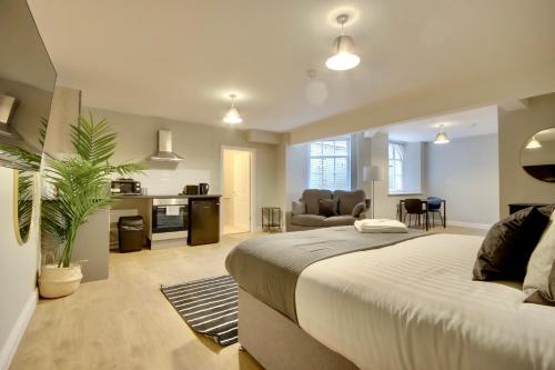 a bedroom with a large bed and a living room at The Mansion in Southampton