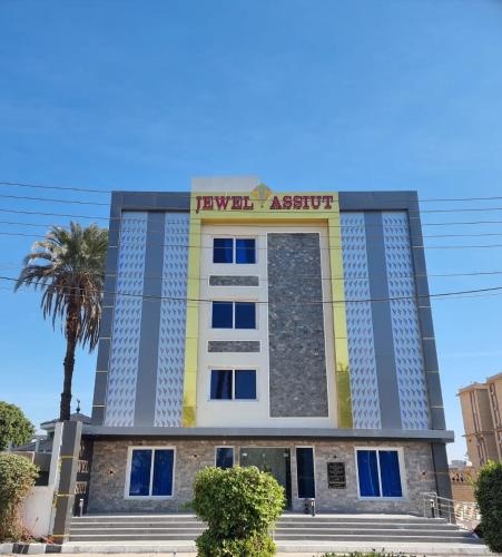 a building with a sign on top of it at Jewel Assiut Hotel in Asyut