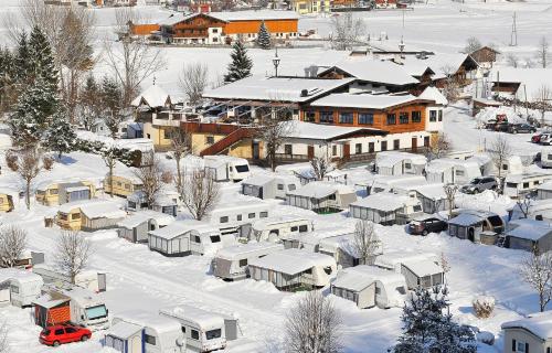 an aerial view of a snow covered town with houses at Feriendorf Seeblick Toni in Kramsach