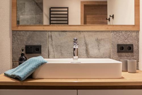 a white bathroom sink with a faucet on a counter at Apartment Mountainview in Neustift im Stubaital