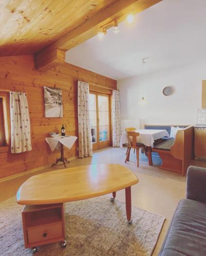 a living room with a table and a dining room at Hof Oberhaus in Kitzbühel